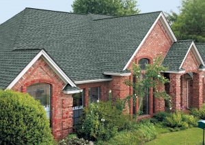 Red brick home with asphalt shingle roofing.