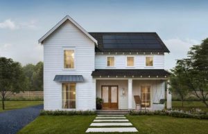 Beautiful two-story home with white siding and a dark solar roofing system.